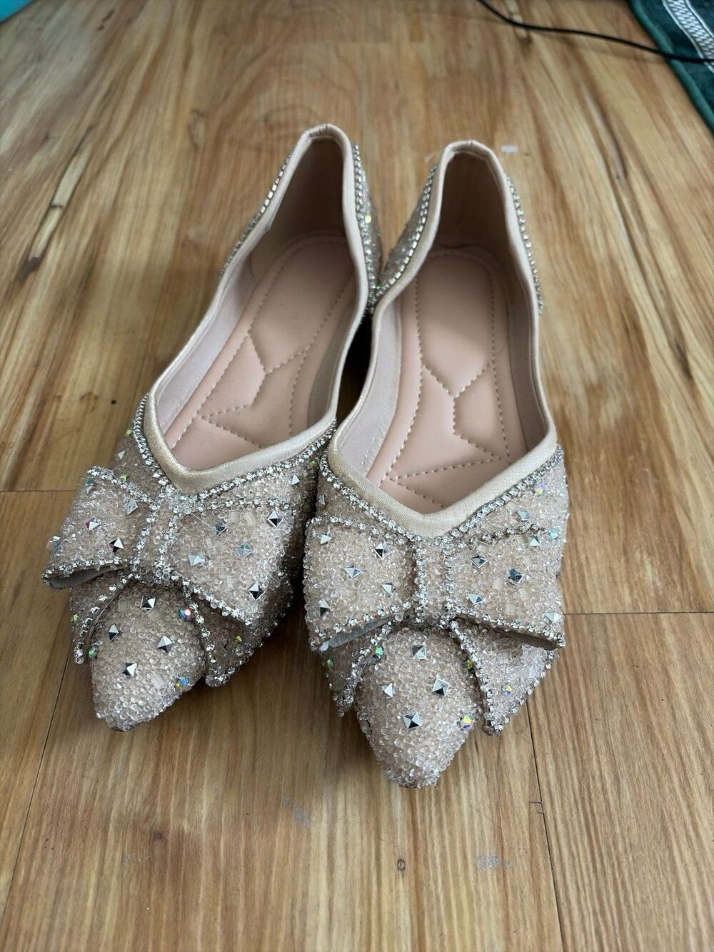 sparkly pointed-toe flat shoes featuring an elegant rhinestone-embellished bow